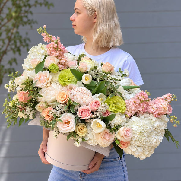 Large pastel box arrangement of hydrangea, peach roses, stock and tulips in Los Angeles