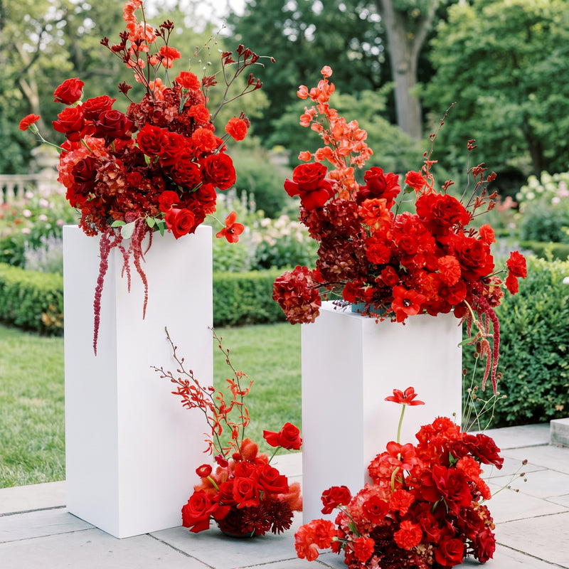 Dramatic red pedestal floral collection in an elegant garden setting — Los Angeles wedding florist, Pink Clover