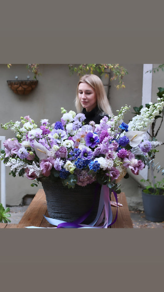 Elegant bouquet showcasing rich purple tones with fresh tulips and lavender roses, ideal for special occasions