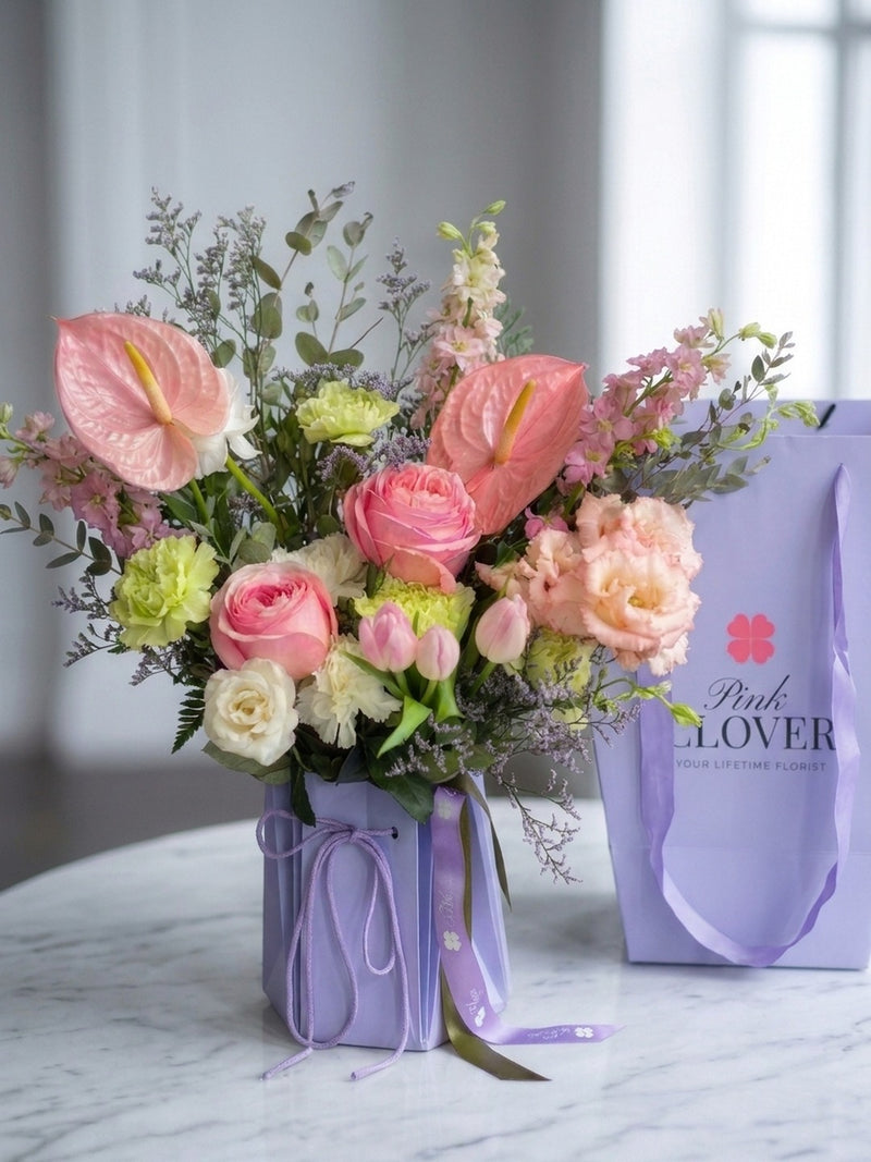 Lavender blush bouquet with pink anthurium and roses in a lavender Pink Clover box — Los Angeles