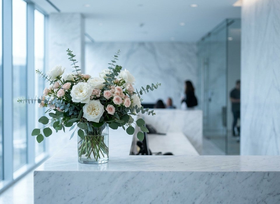 white and blush roses on a marble office reception desk in Los Angeles