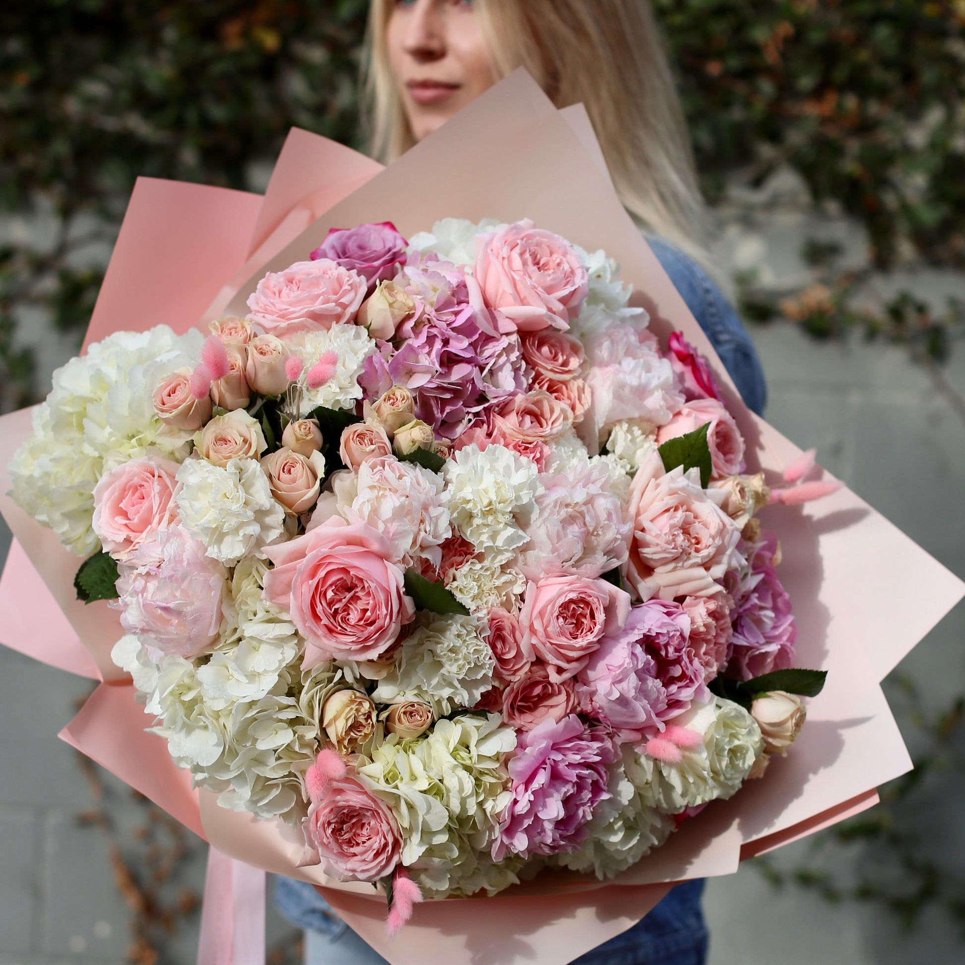 Elegant Milana bouquet featuring peonies, garden roses and greenery in a clear glass vase – ideal for premium floral delivery and romantic occasions