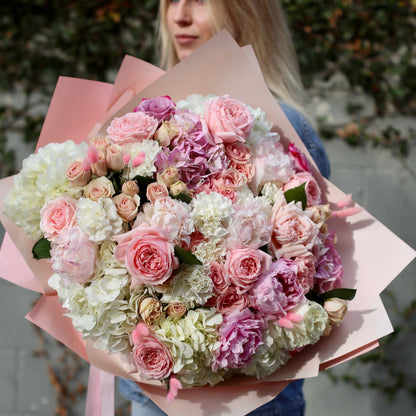 Elegant Milana bouquet featuring peonies, garden roses and greenery in a clear glass vase – ideal for premium floral delivery and romantic occasions