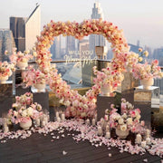 Pink Clover luxury proposal decor: pink & white roses, heart arch, petals, candles, Los Angeles.
