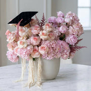 Luxury blush graduation flower arrangement with graduation cap in Los Angeles