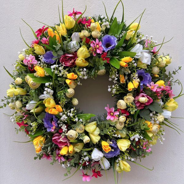 Pink Clover vibrant spring wreath with yellow tulips, purple anemones, pink flowers, lush greenery, Los Angeles.