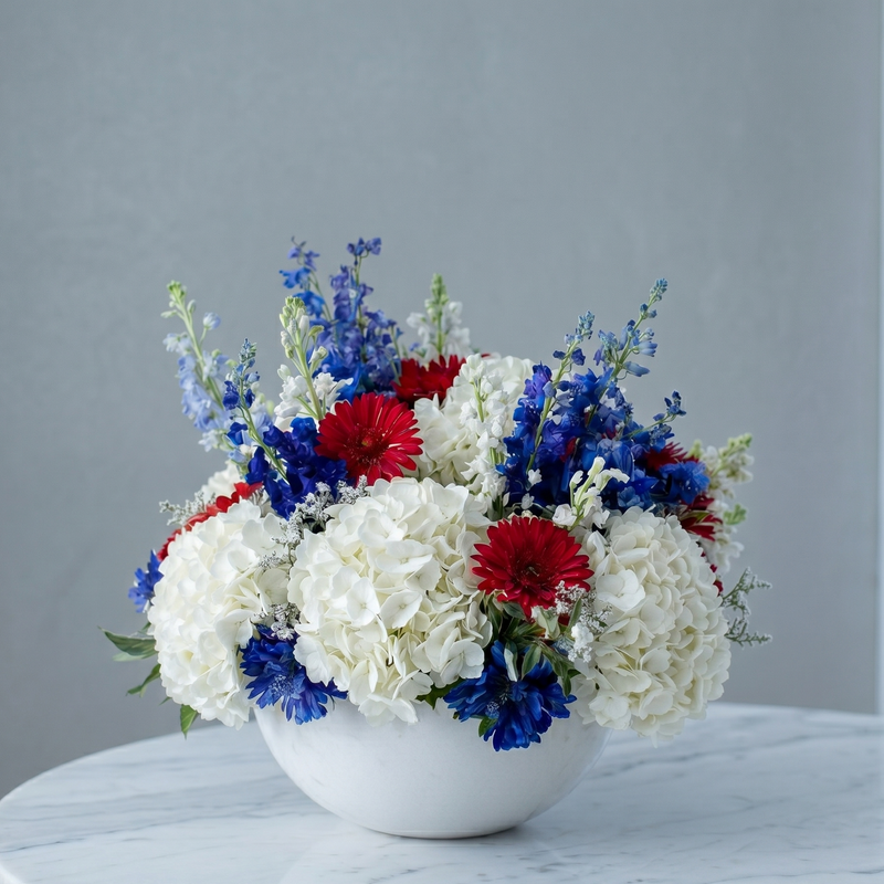 Patriotic Celebration Centerpiece: Red gerberas, white hydrangeas, blue delphinium, dense