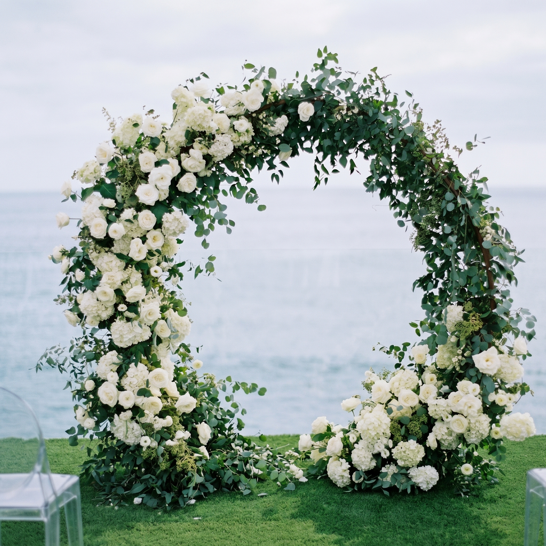 Wedding Circle Arch with white roses, hydrangeas, eucalyptus. Lush floral design by Pink Clover, Los Angeles.