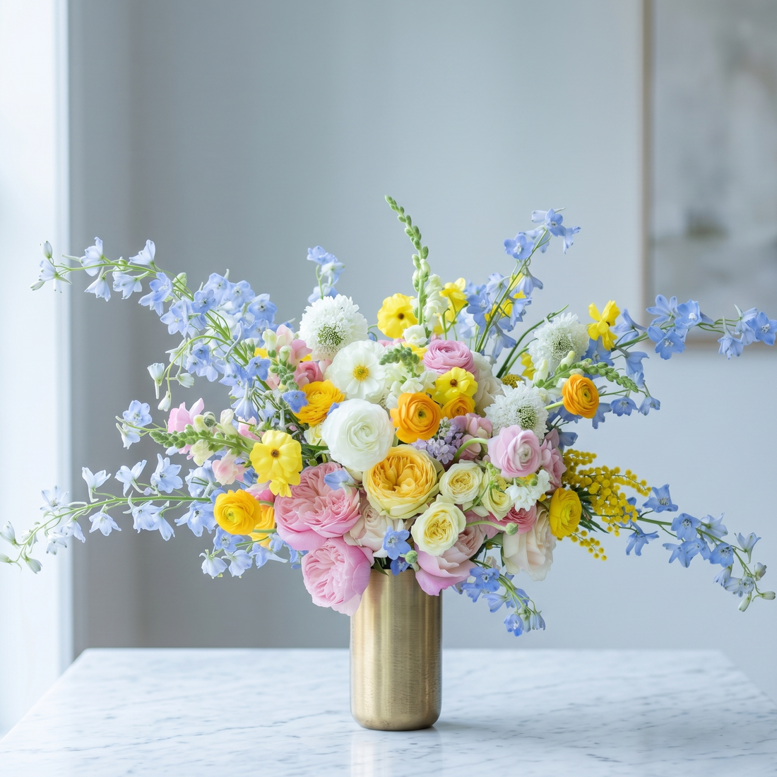Pink Clover's vibrant spring bouquet: pink roses, yellow ranunculus, blue delphinium, white mums, Los