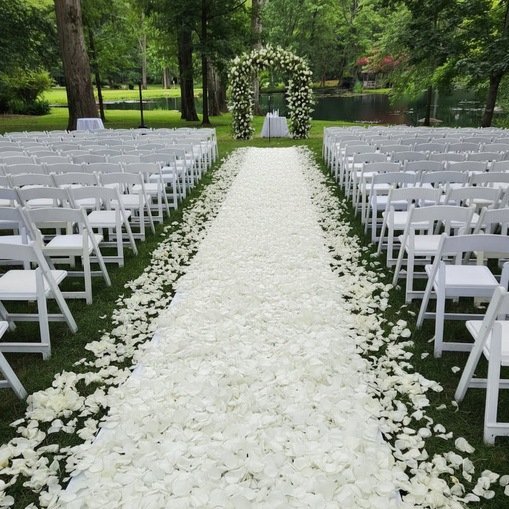 White rose petal aisle, lush floral arch by Pink Clover. Bridal Petal Path for elegant outdoor weddings Los Angeles.