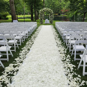 White rose petal aisle, lush floral arch by Pink Clover. Bridal Petal Path for elegant outdoor weddings Los Angeles.