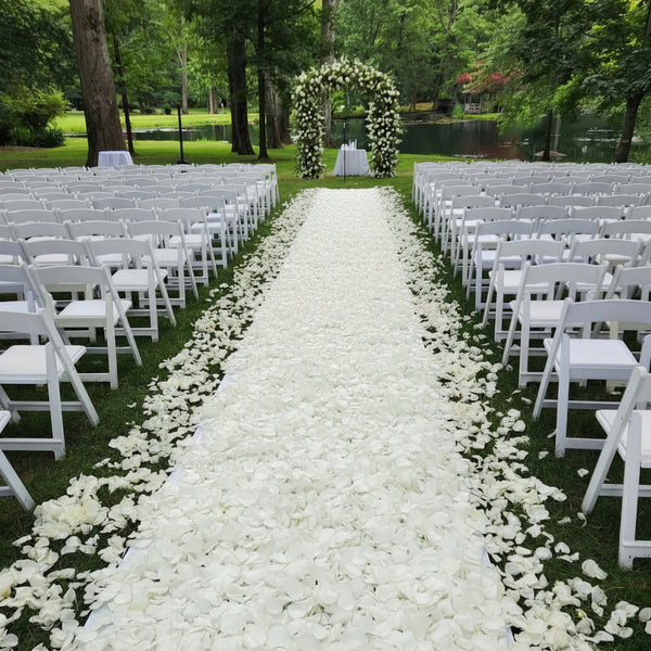 White rose petal aisle, lush floral arch by Pink Clover. Bridal Petal Path for elegant outdoor weddings Los Angeles.