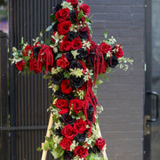 Handcrafted sympathy arrangement showcasing a floral cross design, ideal for honoring cherished memories