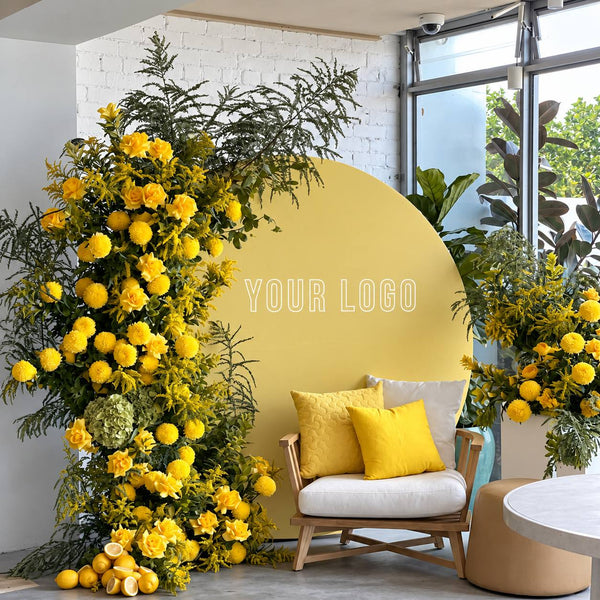 Yellow floral brand activation lounge with logo backdrop, Los Angeles