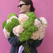 Elegant bouquet of blush flowers with mint accents, ideal for serene celebrations