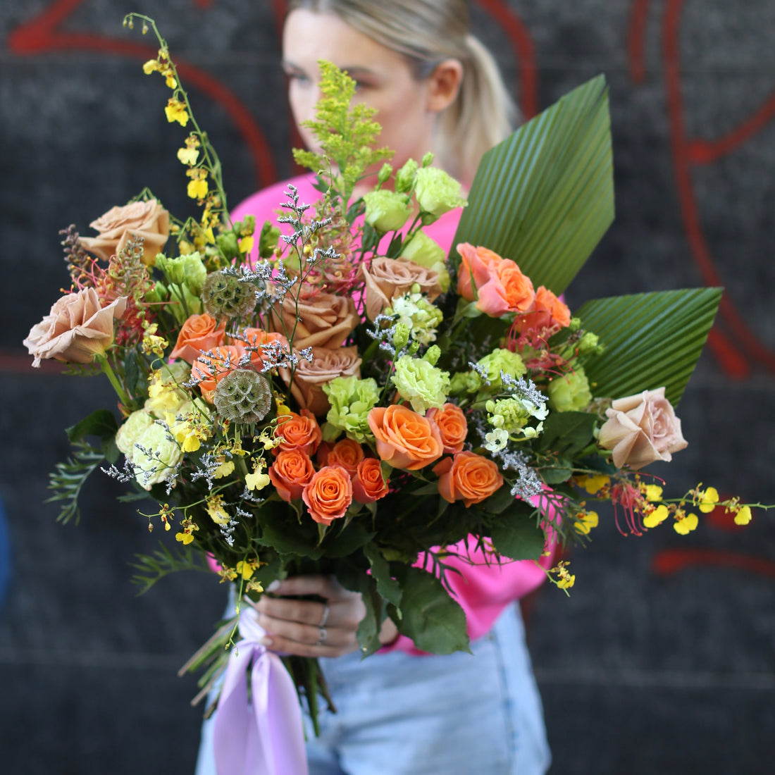 Vibrant Bouquet Brightness floral arrangement featuring yellow roses, carnations, and alstroemeria in a joyful, colorful composition