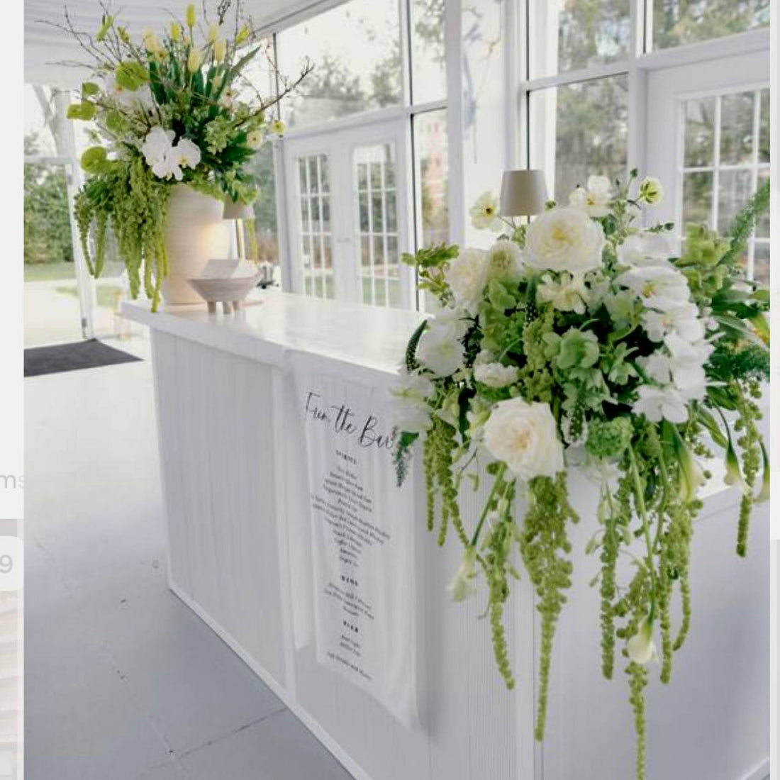 Cascading white roses and orchids bar floral installation for luxury Los Angeles weddings