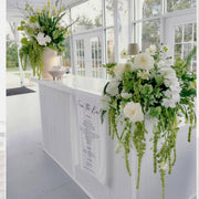 Cascading white roses and orchids bar floral installation for luxury Los Angeles weddings