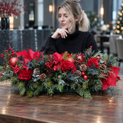 Red Christmas centerpiece with roses, poinsettia and pine, delivered in Los Angeles by Pink Clover
