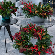 Christmas set of two red berry and magnolia arrangements, delivered in Los Angeles by Pink Clover