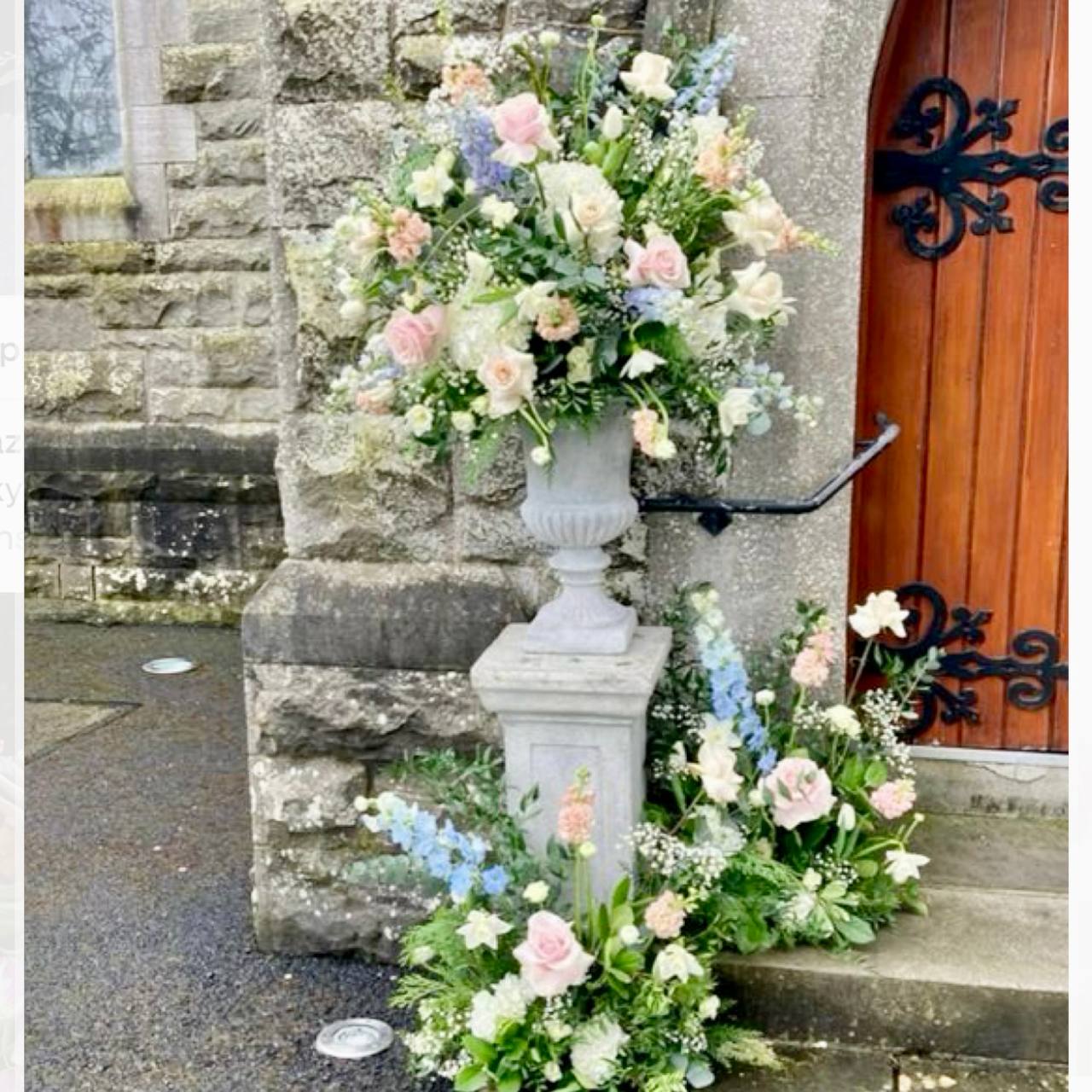 Church entrance pedestal floral set with pink roses and delphinium for Los Angeles ceremonies