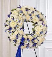 Elegant Circle Spray Blue standing wreath with blue and white flowers, ideal for funeral services and premium floral delivery