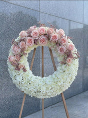 Pink rose sympathy wreath on easel, Los Angeles funeral flower delivery