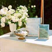 Classic white ranunculus bar arrangement in stone vase for Los Angeles events