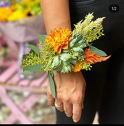Elegant corsage design featuring fresh roses and greenery, styled for weddings and formal events