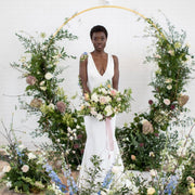 Bespoke floral arch with cascading orchids and roses, perfect for luxury weddings