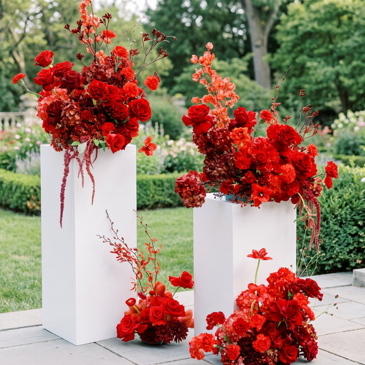 Dramatic red pedestal floral collection in an elegant garden setting — Los Angeles wedding florist, Pink Clover