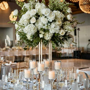 Elevated white rose and hydrangea centerpiece on gold stand for Los Angeles ballroom weddings