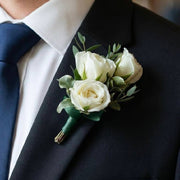 White Rose Boutonnière worn on a suit lapel — Los Angeles wedding florist