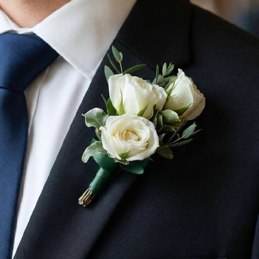 White Rose Boutonnière worn on a suit lapel — Los Angeles wedding florist