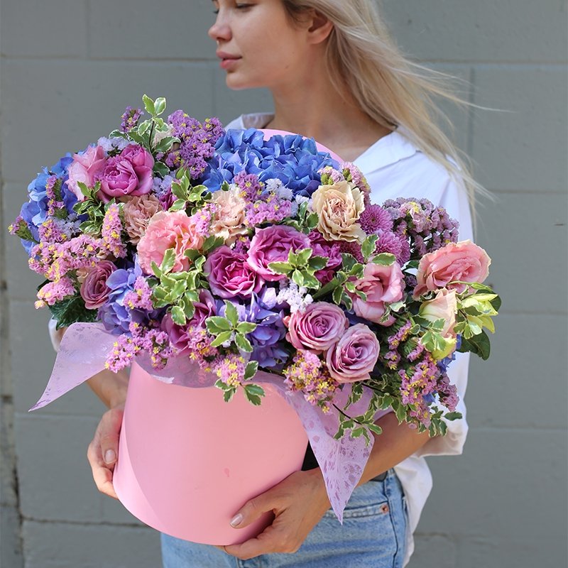 Luxurious pink floral arrangement featuring roses, hydrangeas & garden blooms in a round decorative box – ideal for premium gifting