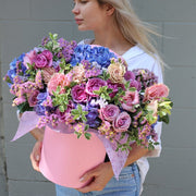 Luxurious pink floral arrangement featuring roses, hydrangeas & garden blooms in a round decorative box – ideal for premium gifting