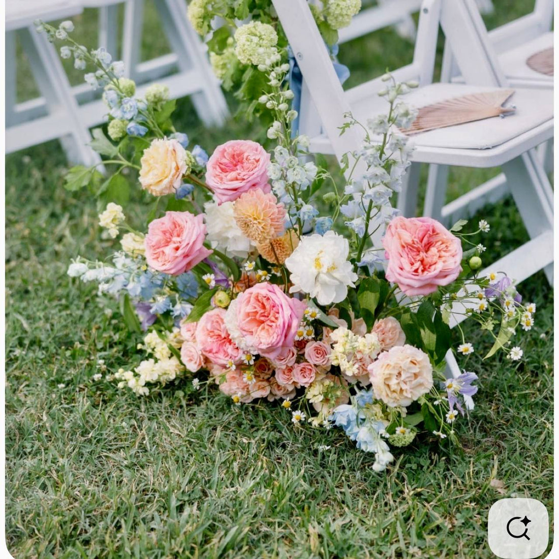 Garden aisle arrangement with pink roses and blue delphinium for outdoor Los Angeles weddings