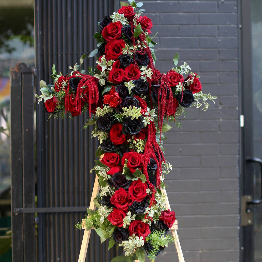 Elegant floral cross arrangement with white blooms, symbolizing peace and reverence
