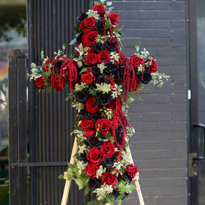 Elegant floral cross arrangement with white blooms, symbolizing peace and reverence
