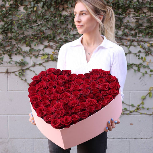 Elegant red rose arrangement in a modern heart box, ideal for anniversaries and grand romantic gestures
