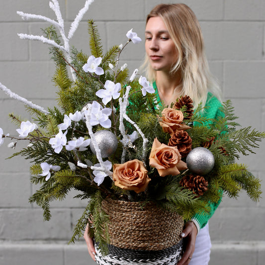 Festive floral Christmas tree design featuring soft blooms and greenery, perfect for seasonal decor and gifting