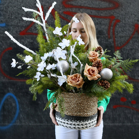 Elegant Christmas tree decorated with white roses, pinecones and festive natural accents for a luxurious holiday look