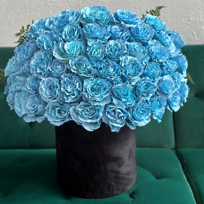 Full view of the bouquet showcasing soft blue tones, layered textures, and delicate stems wrapped in kraft paper.
