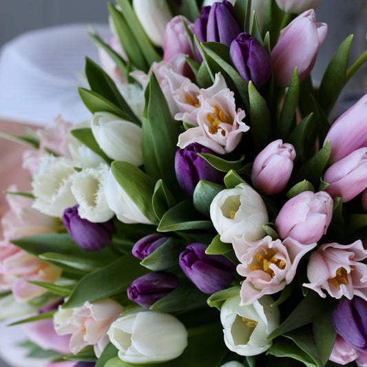 Fresh spring floral arrangement featuring a colorful mix of tulips, styled for elegant presentation and premium delivery