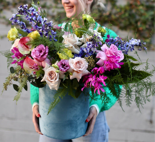 Vibrant yellow and pink bouquet in a decorative box, showcasing fresh blooms for a joyful and luxurious presentation