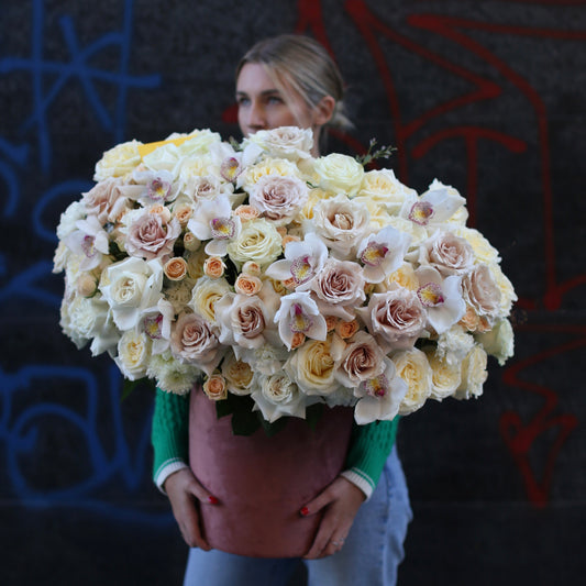 Elegant Luxe White Bouquet featuring fresh white roses and lilies, beautifully wrapped in soft, luxurious styling