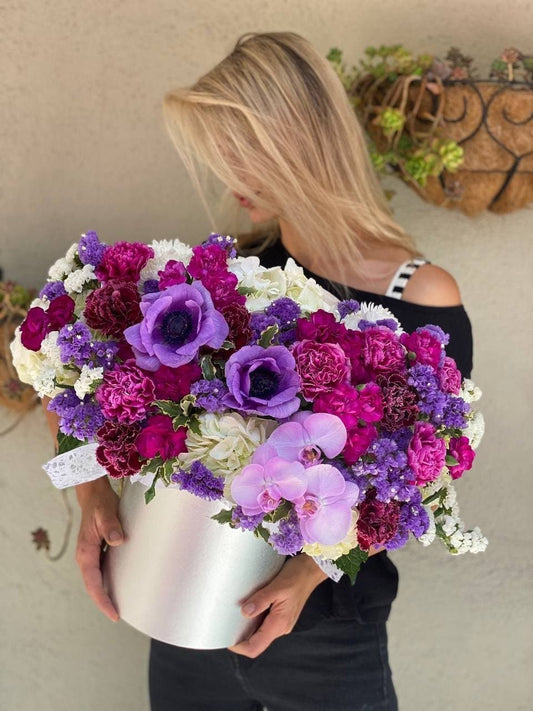Elegant Josephine bouquet featuring hydrangeas, anemones, and carnations in soft purple tones, styled for premium gifting