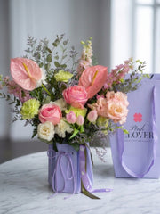Lavender blush bouquet with pink anthurium and roses in a lavender Pink Clover box — Los Angeles