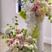 Orchid column installation with cascading phalaenopsis and dahlias for luxury Los Angeles events