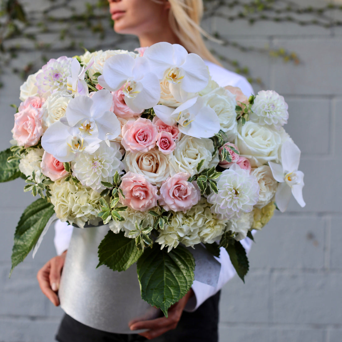 Luxurious Lana floral arrangement featuring orchids, garden roses and dahlias styled in a decorative keepsake box for premium gifting